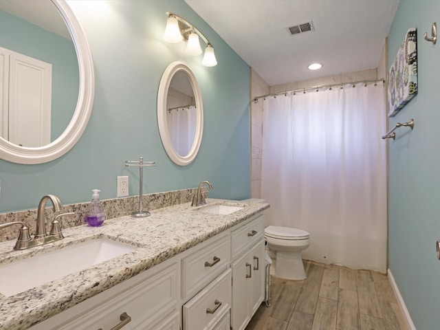 bathroom with vanity, toilet, hardwood / wood-style flooring, and a shower with curtain