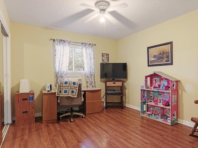 office space featuring a textured ceiling, hardwood / wood-style flooring, and ceiling fan