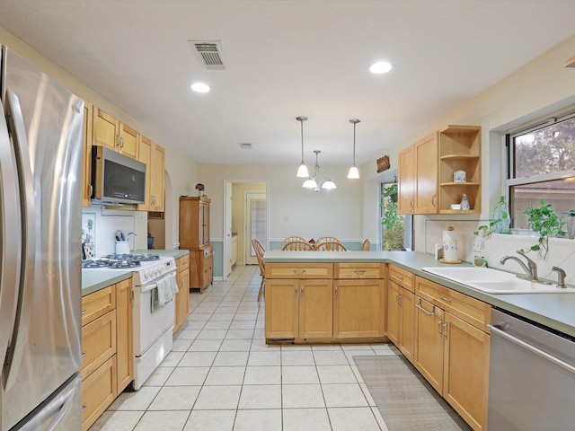 kitchen featuring kitchen peninsula, sink, light tile patterned flooring, pendant lighting, and appliances with stainless steel finishes