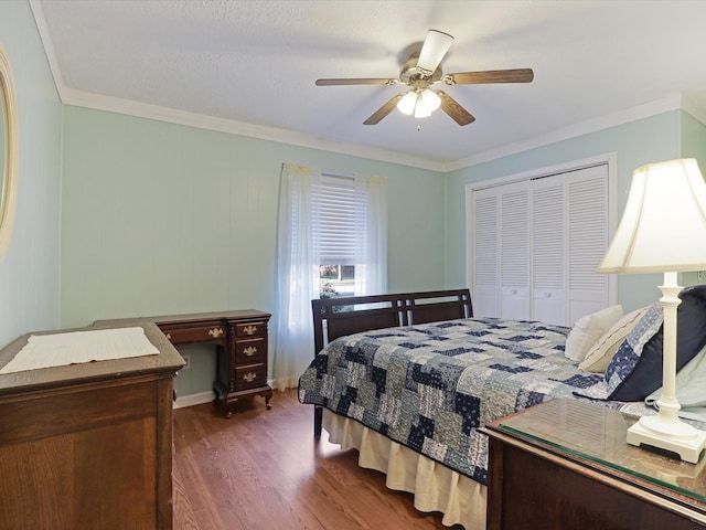 bedroom featuring a closet, ceiling fan, wooden walls, dark wood-type flooring, and crown molding