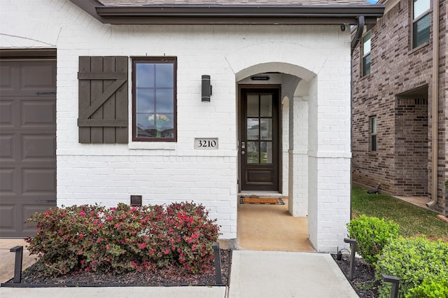 view of exterior entry with a garage