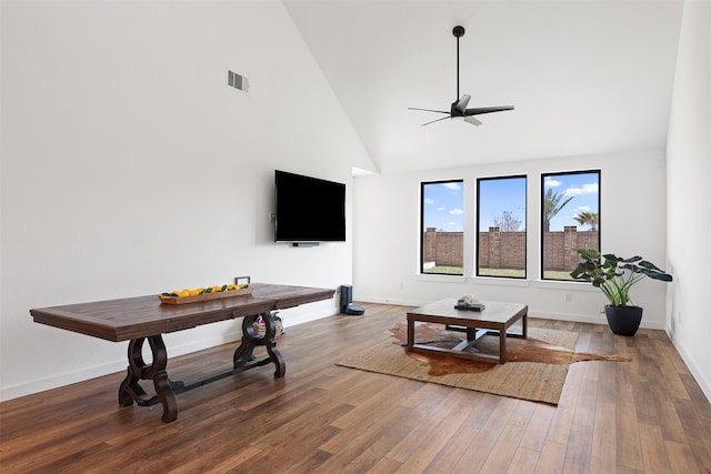 living room featuring ceiling fan, high vaulted ceiling, and wood-type flooring