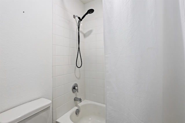 bathroom featuring toilet and shower / bath combo