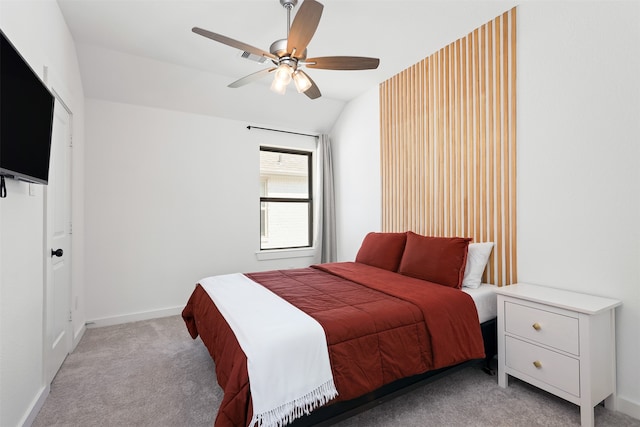 bedroom featuring ceiling fan, vaulted ceiling, and light colored carpet