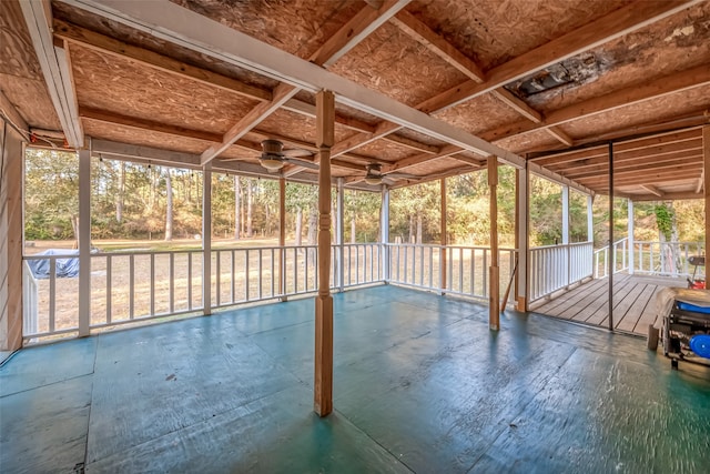 unfurnished sunroom featuring ceiling fan