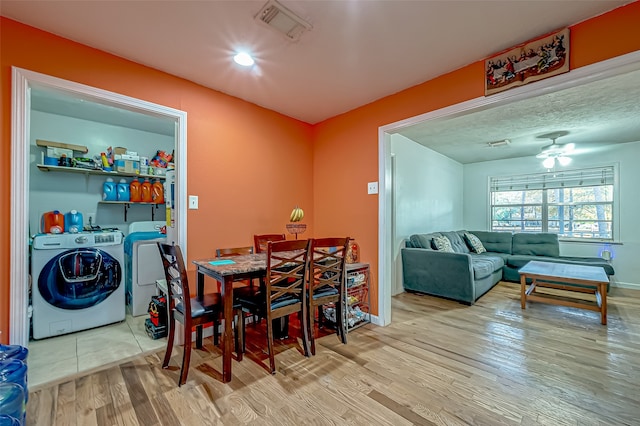 dining room featuring independent washer and dryer, light hardwood / wood-style flooring, and ceiling fan