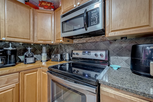 kitchen featuring backsplash and stainless steel appliances