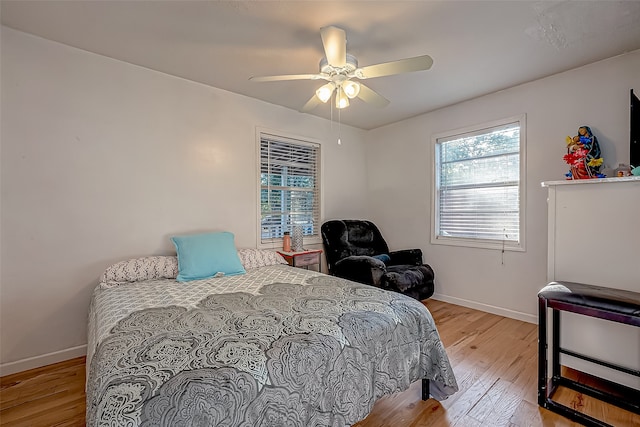 bedroom with ceiling fan and light wood-type flooring