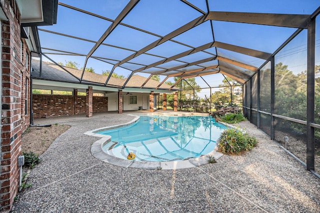 view of swimming pool with a patio and glass enclosure