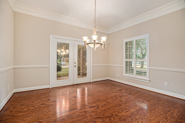 spare room featuring ornamental molding, dark hardwood / wood-style flooring, french doors, and an inviting chandelier