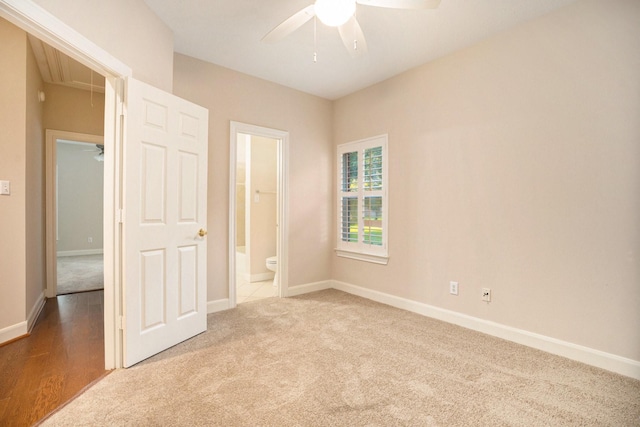 unfurnished bedroom with ensuite bath, ceiling fan, and carpet flooring