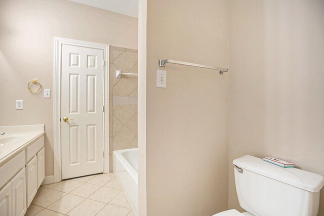 full bathroom featuring tile patterned flooring, tiled shower / bath combo, vanity, and toilet