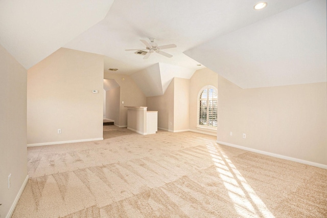 additional living space featuring vaulted ceiling, light colored carpet, and ceiling fan