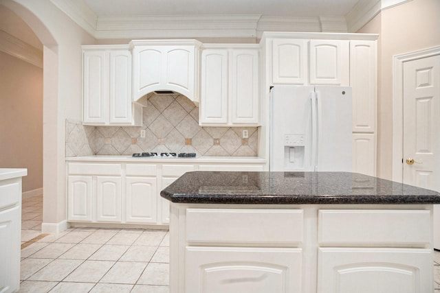 kitchen featuring white appliances, a center island, and white cabinets