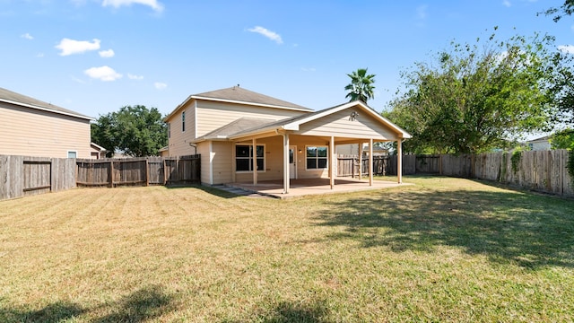 rear view of property featuring a patio area and a lawn