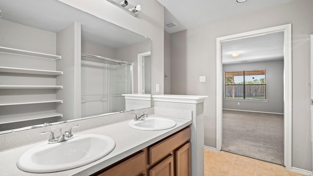 2038 Adobe Stone Dr, Humble, TX 77396 - bathroom with a sink, a shower with door, double vanity, and visible vents
