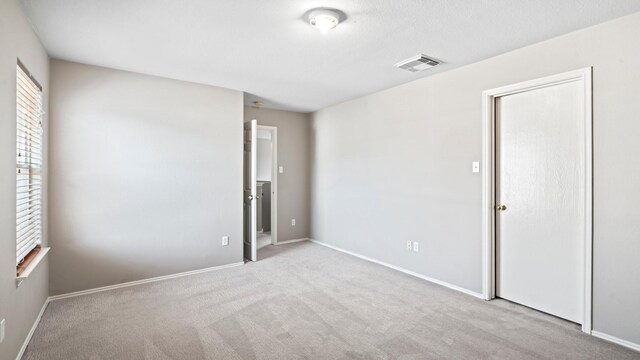 2038 Adobe Stone Dr, Humble, TX 77396 - unfurnished bedroom featuring baseboards, visible vents, and carpet floors