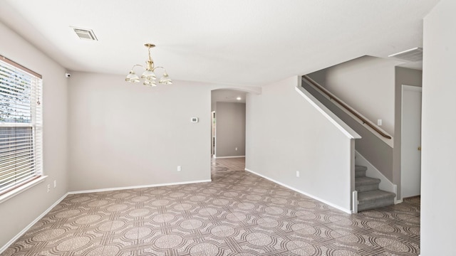 2038 Adobe Stone Dr, Humble, TX 77396 - empty room featuring baseboards, visible vents, stairs, a chandelier, and arched walkways