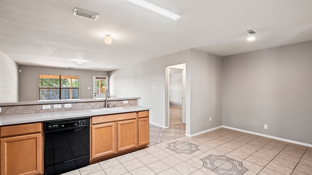 kitchen featuring sink, light tile patterned floors, and dishwasher