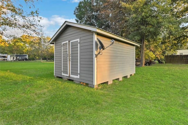 view of outbuilding with a yard