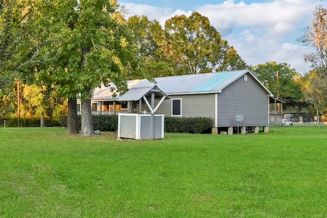 back of house with a lawn