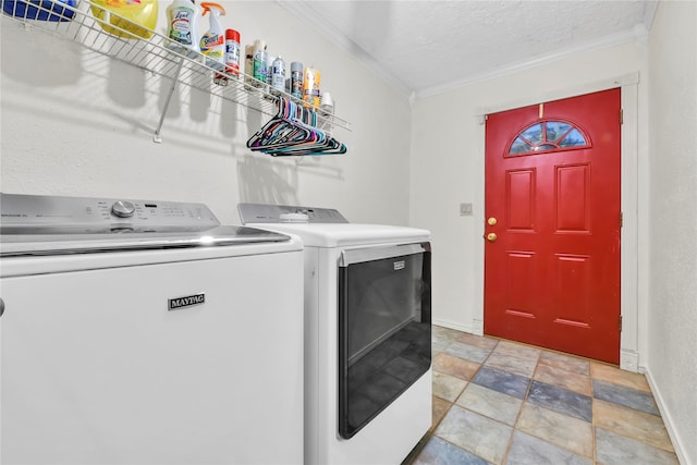 laundry room featuring crown molding, washer and dryer, and a textured ceiling