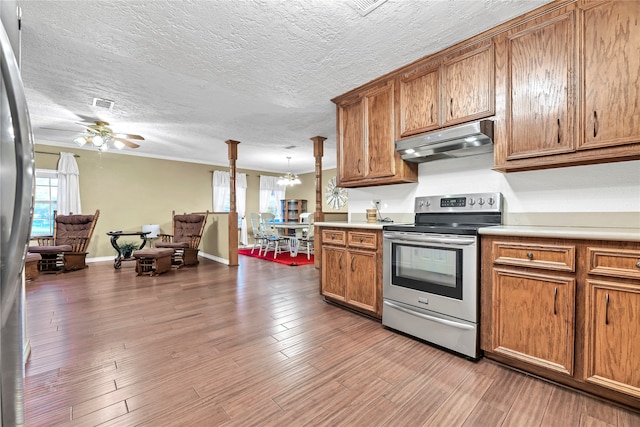 kitchen with electric stove, wood-type flooring, pendant lighting, and ceiling fan with notable chandelier