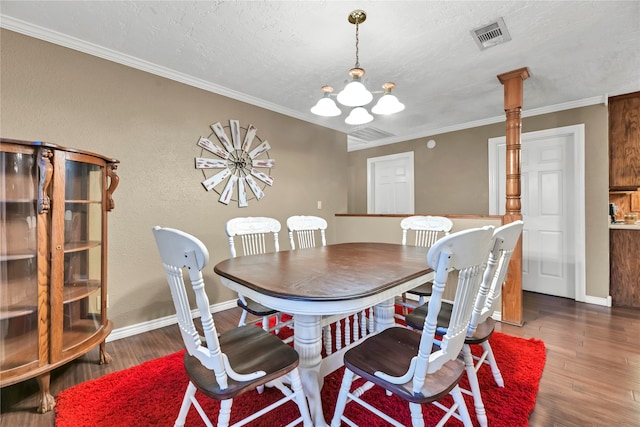 dining space with ornamental molding, a chandelier, dark wood-type flooring, and a textured ceiling