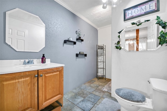 bathroom with vanity, toilet, and ornamental molding