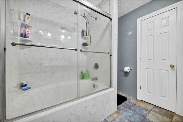 bathroom featuring bath / shower combo with glass door