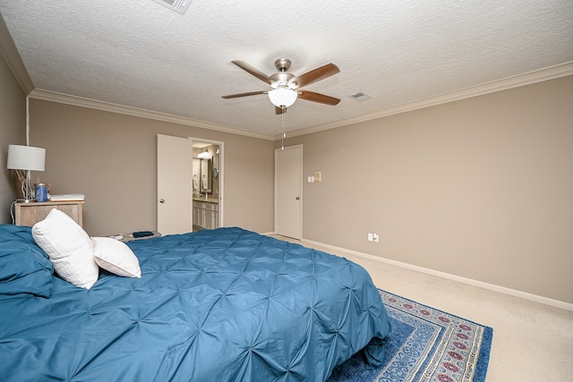 carpeted bedroom featuring ornamental molding, a textured ceiling, ensuite bathroom, and ceiling fan