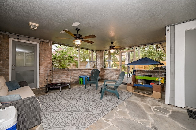 view of patio featuring ceiling fan