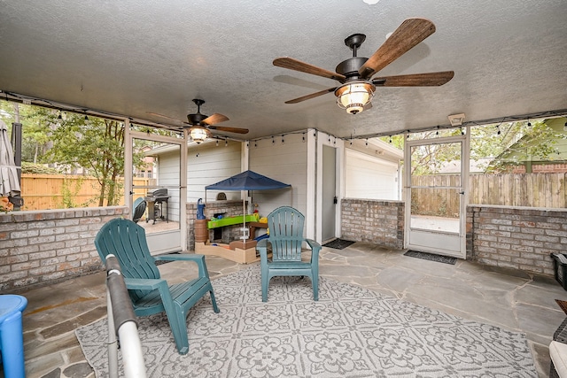 sunroom / solarium with ceiling fan