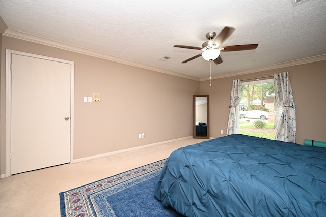 carpeted bedroom featuring ornamental molding, a textured ceiling, and ceiling fan