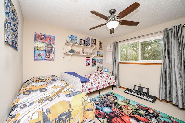 bedroom with ceiling fan and a textured ceiling