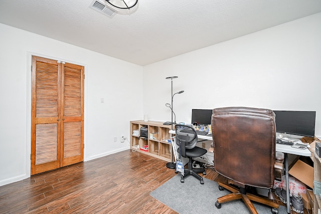 office space with a textured ceiling and dark wood-type flooring