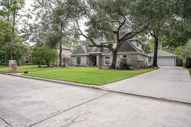 view of front of property with a front yard and a garage