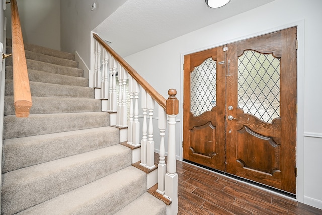 foyer entrance with dark hardwood / wood-style flooring