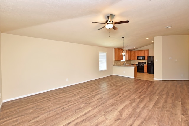 unfurnished living room with lofted ceiling, a textured ceiling, light wood-type flooring, and ceiling fan