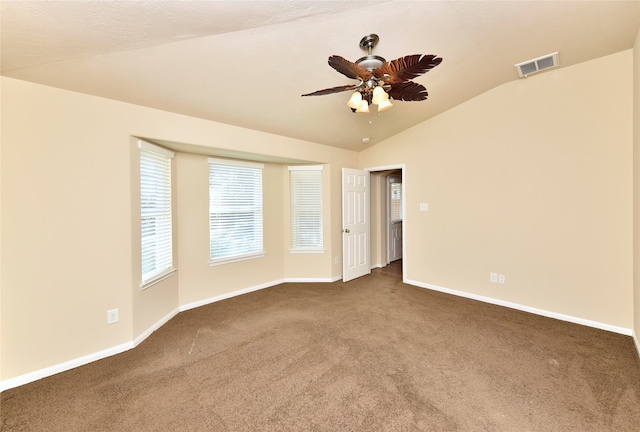 carpeted empty room featuring ceiling fan and lofted ceiling