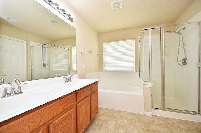 bathroom with vanity and independent shower and bath