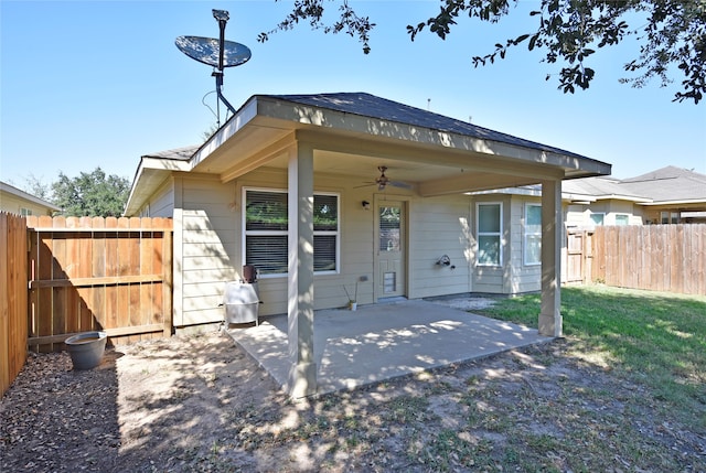 rear view of house featuring a yard, ceiling fan, and a patio area