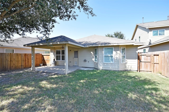 back of property with a patio and a yard