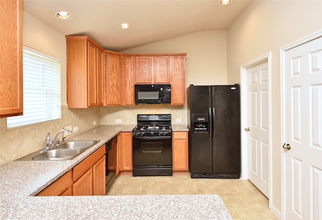 kitchen featuring black appliances, sink, backsplash, lofted ceiling, and light tile patterned floors