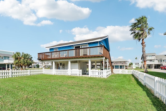 back of house featuring a wooden deck and a lawn