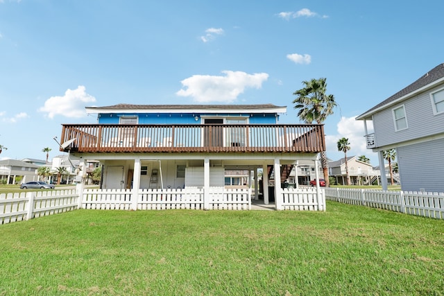 rear view of house with a wooden deck and a yard