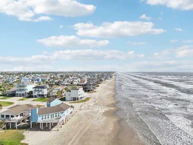 drone / aerial view with a water view and a beach view