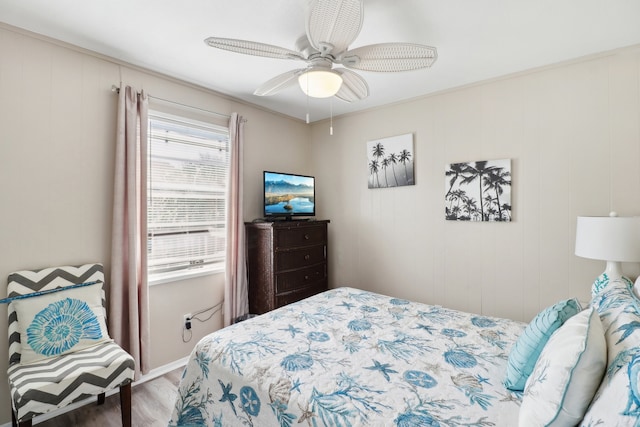 bedroom featuring ornamental molding, hardwood / wood-style floors, and ceiling fan