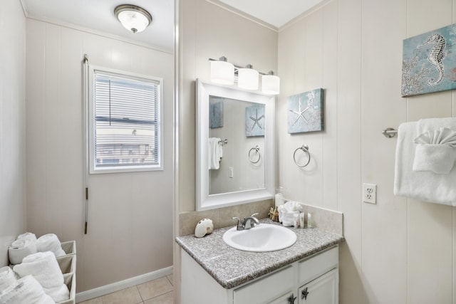 bathroom featuring vanity, ornamental molding, wooden walls, and tile patterned floors