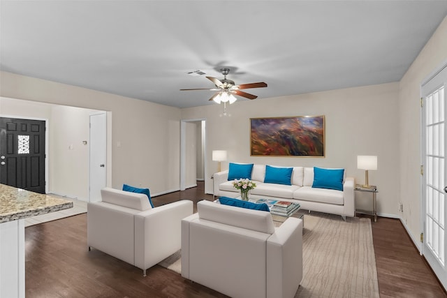 living room with dark hardwood / wood-style floors and ceiling fan